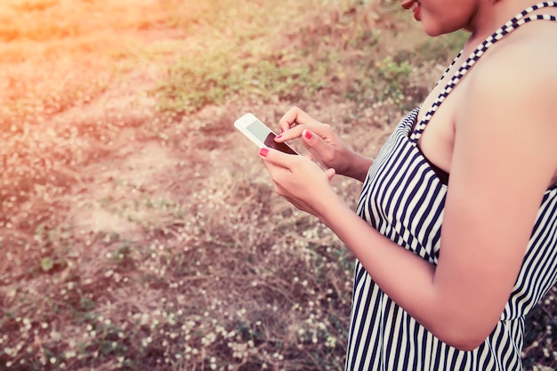 Free photo close-up of woman using her phone in the field