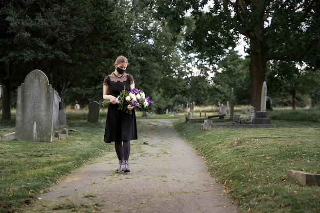 Free Photo close up on woman visiting the grave of loved one