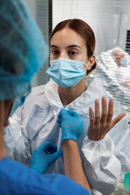 Close up woman wearing hazmat suit and mask