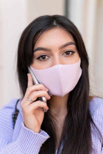 Close up woman wearing pink mask