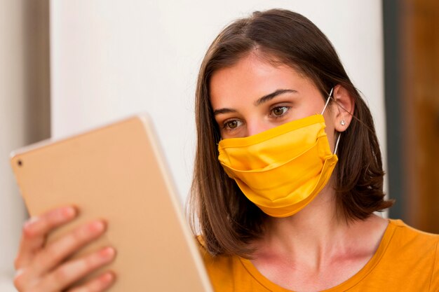 Close-up woman wearing yellow mask