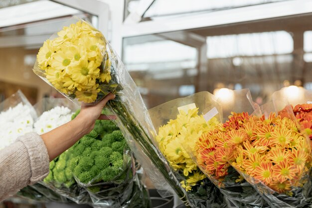 Free Photo close-up woman with bouquet of yellow flowers