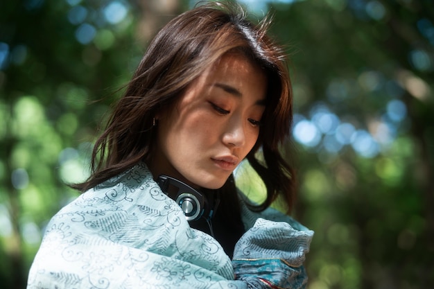 Close up woman with cloth piece and headphones