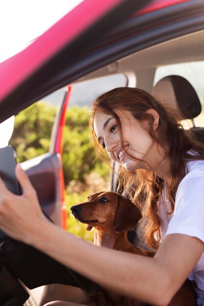 Close up woman with dog in car