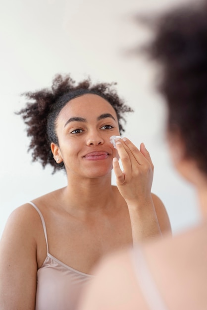 Free photo close up woman with face cream