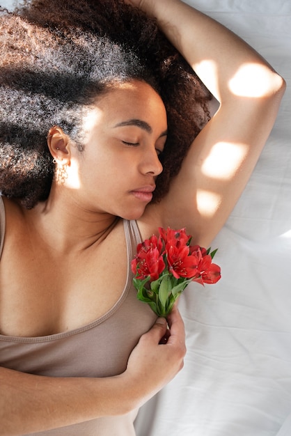 Close up on woman with flowers around armpit