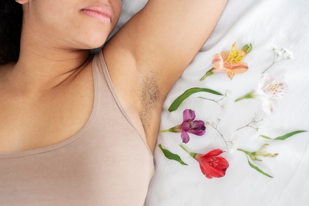 Close up on woman with flowers around armpit