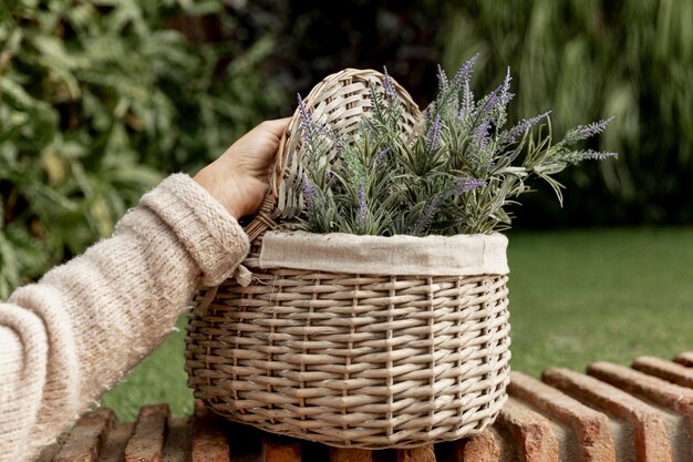 Close-up woman with flowers in a basket