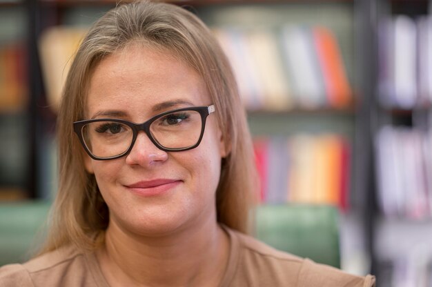 Close-up woman with glasses at library