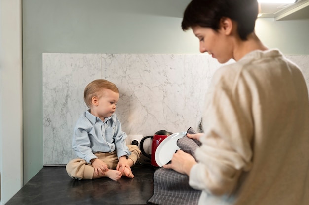 Close up woman with kid cleaning dish