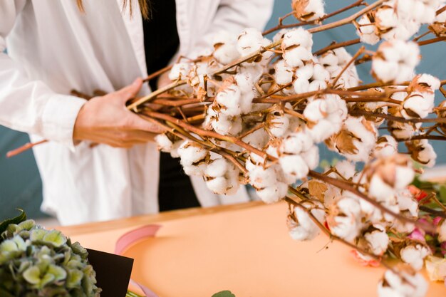 Close-up woman with lab coat holding flowers