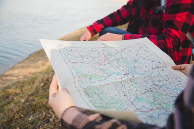 Free photo close-up of woman with map by the lake