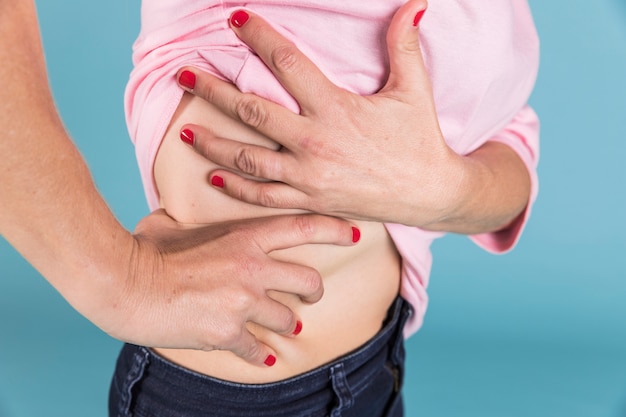 Close-up of a woman with pain in her lower back