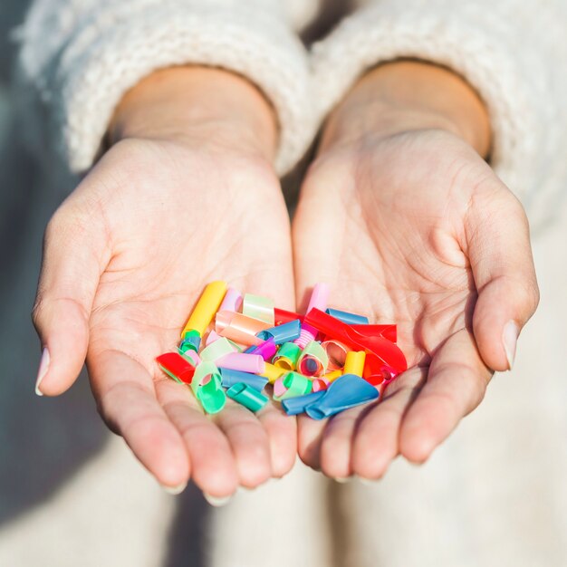 Close-up woman with plastic in hands