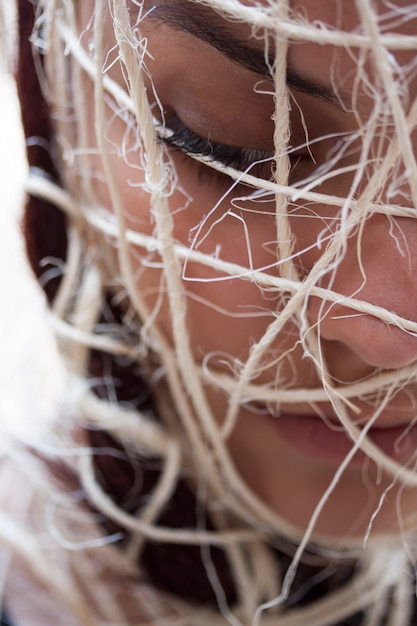 Free photo close-up of woman with ropes around her head