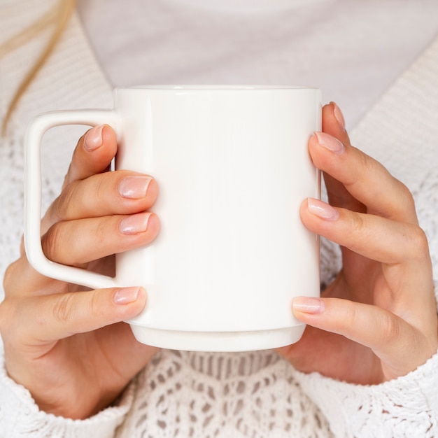 Close-up woman with sweater and mug