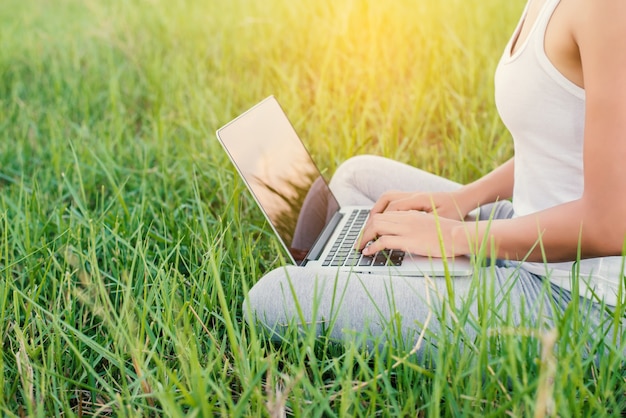 Close-up of a woman working with her laptop outdoors