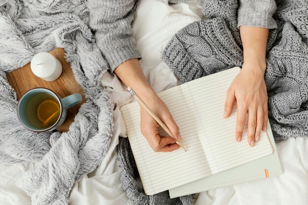 Close up woman writing in notebook