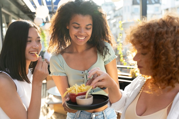 Close up women eating together