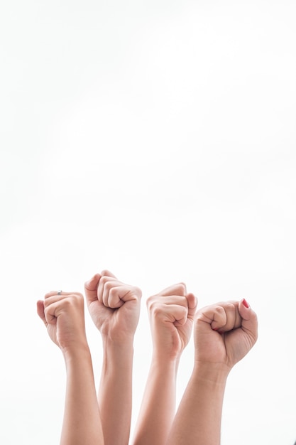 Free Photo close-up women holding fists up at gathering