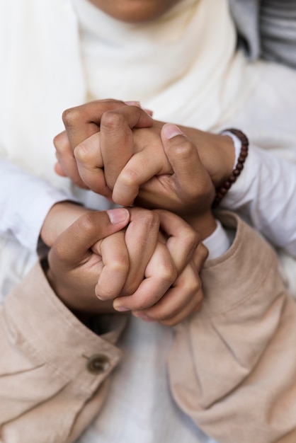 Close up women holding hands