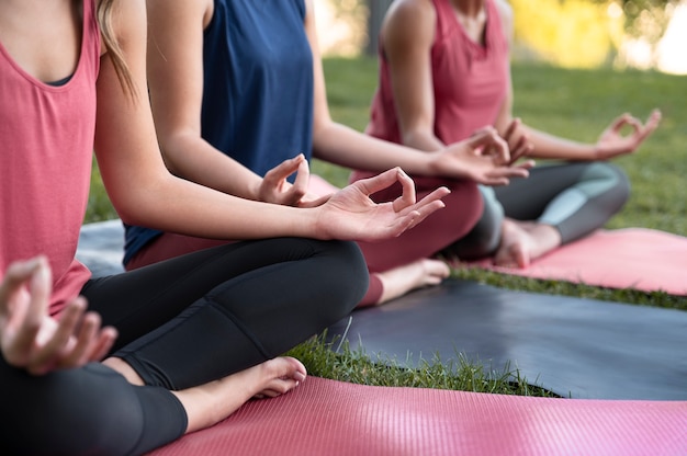 Free photo close up women meditating together