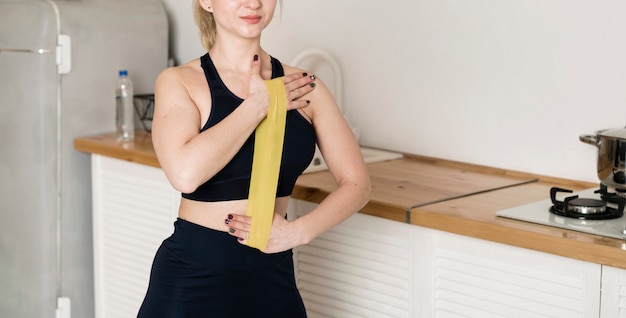 Close-up women training with elastic bands