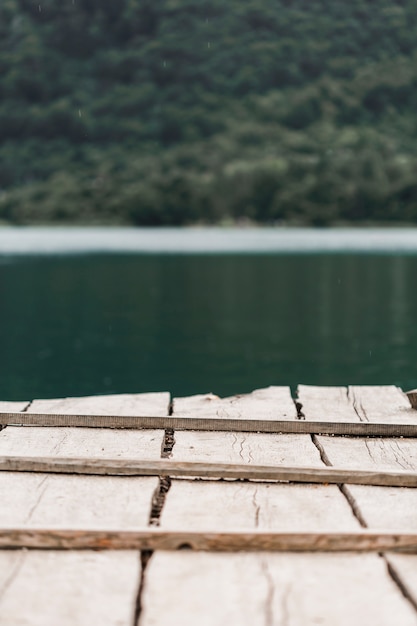 Free photo close-up of wooden pier in front of lake