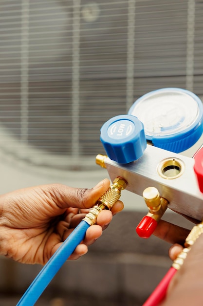 Close up of worker checking freon tank