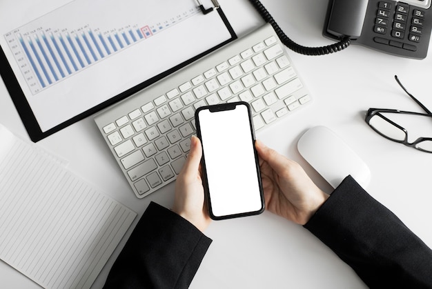 Free Photo close-up worker holding mobile phone