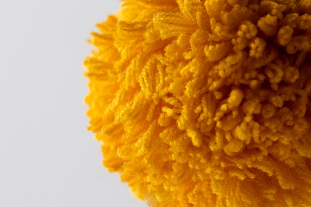 Close up yellow pom pom with white background