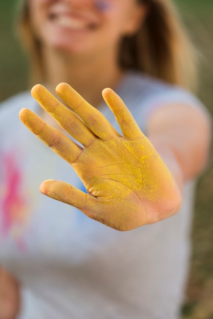 Free Photo close-up of yellow powdered hand