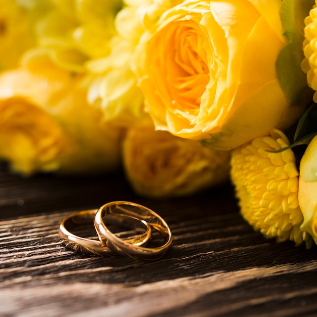 Close-up yellow roses with engagement rings