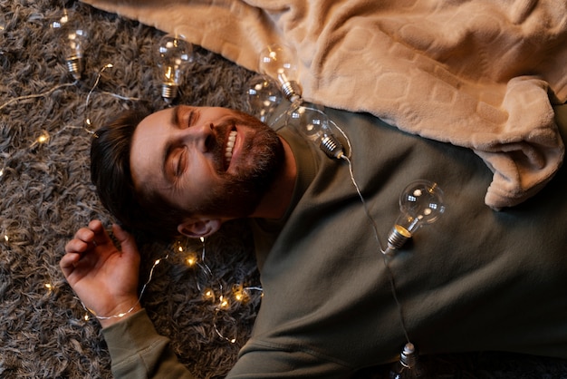 Free photo close up on young adult enjoying christmas lights