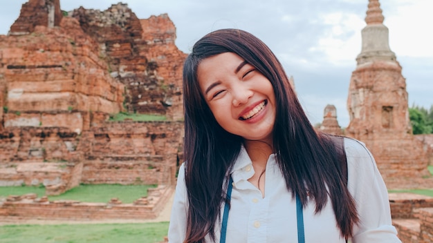 Close-up Young Asian backpacker blogger woman at pagoda old city