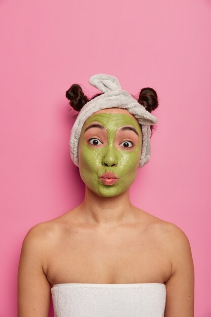 Close up on young beautiful woman with facial mask