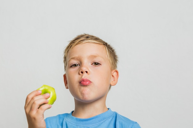 Close-up young boy with an apple