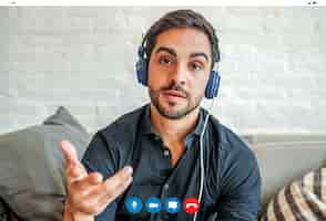 Free photo close-up of a young businessman having a work video call while staying at home. new normal lifestyle. business concept.