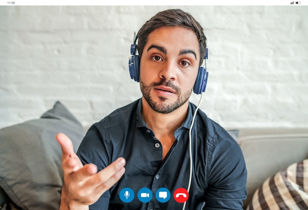 Free Photo close-up of a young businessman having a work video call while staying at home. new normal lifestyle. business concept.