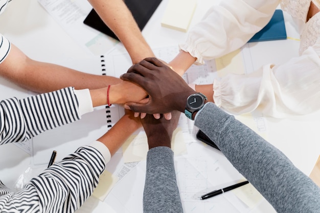 Close up on young colleagues hands in a meeting