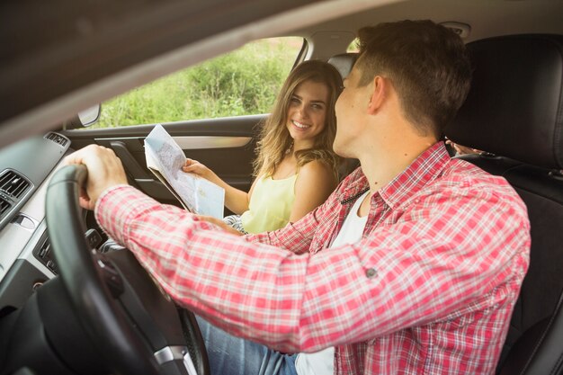 Close-up of young couple enjoying travelling in car