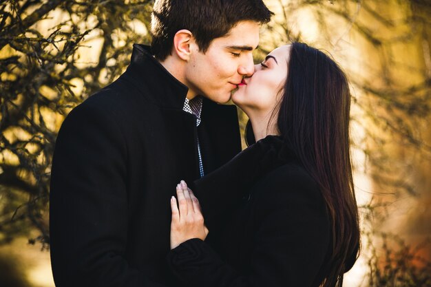 Close-up of young couple kissing in the park