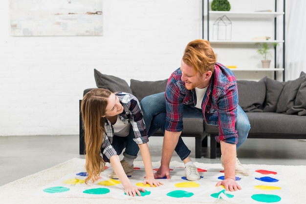 Free Photo close-up of young couple playing color dot game looking at each other