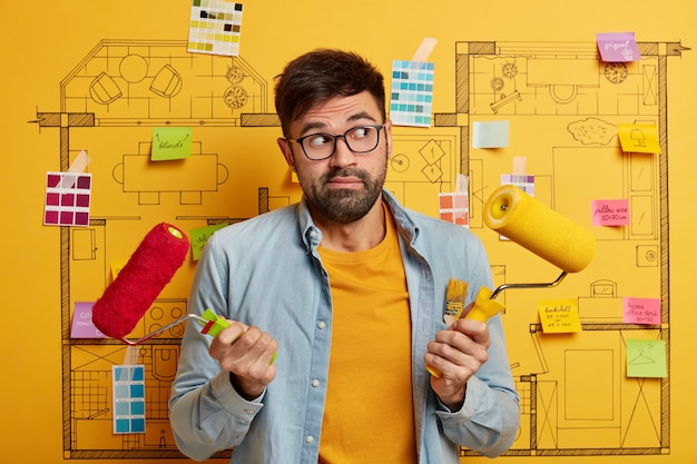 Free photo close up on young designer getting ready to renovate next to house master plan sketch