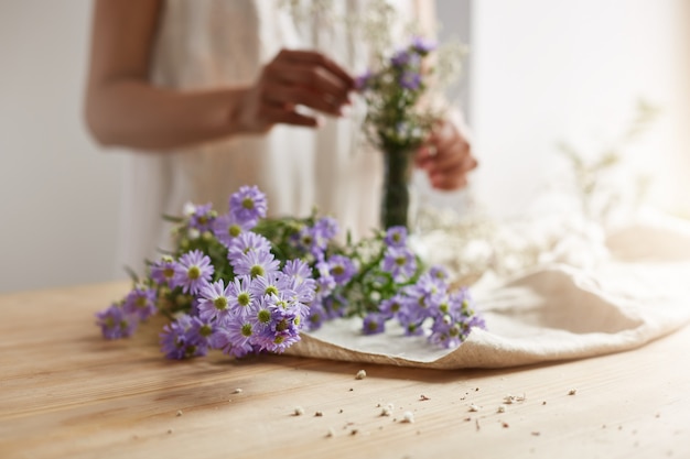 Free photo close up of young female florist making tender bouquet at workplace. copy space.