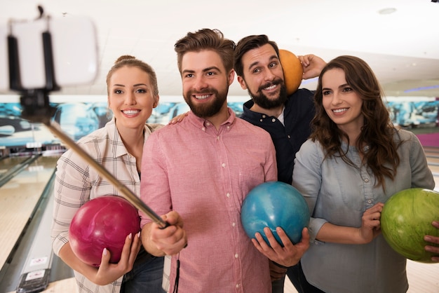 Close up on young friends enjoying bowling