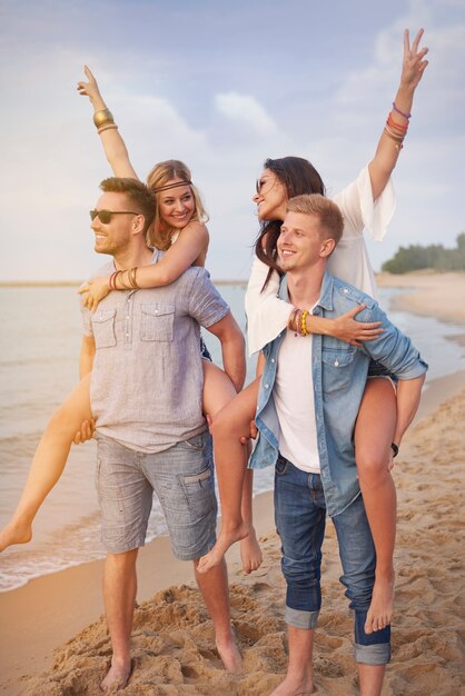 Close up on young friends having fun on the beach