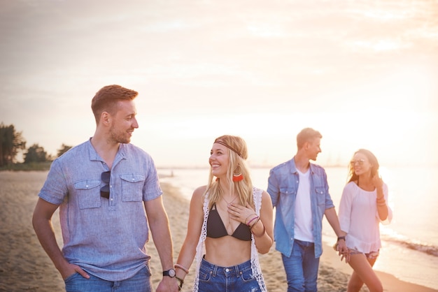 Close up on young friends having fun on the beach