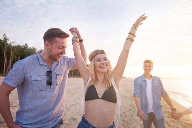 Close up on young friends having fun on the beach