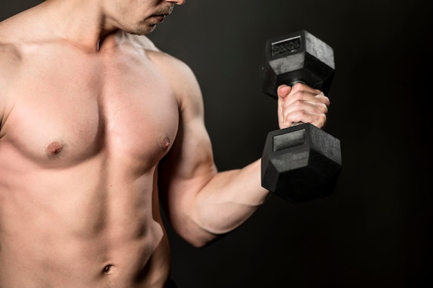 Close-up young man lifthing weights